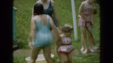Wellsburg Iowa (1965): Little Girl Playing In Water During Summer Season.