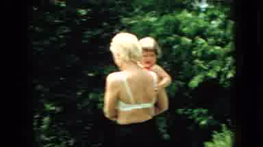 Wellsburg Iowa (1965): Women And Children Playing Outside With A Water Hose.