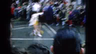 Wellsburg Iowa (1965): People In Matching Costumes And Hats Walking Through A