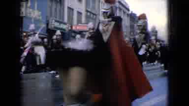 Wellsburg Iowa (1965): People Watching A Band Marching Down A Street
