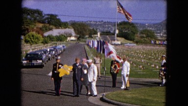 1966: CEREMONY PUNCHBOWL LAKE WILSON KAPIOLANI PARK. PANNING A MONUMENT WITH STONE CARVINGS