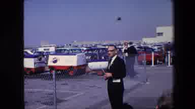Amsterdam Netherlands (1967): A Mountain, And A Man Standing In A Parking Lot.