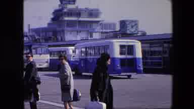 Amsterdam Netherlands (1967): A Lady In A Mink Coat Walking Towards A Bus.