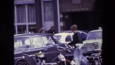 Amsterdam Netherlands (1967): A Young Man Walks His Bike Through The City To A