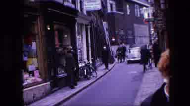 Amsterdam Netherlands (1967): Cars Driving Down A Busy Street As People Walk By.