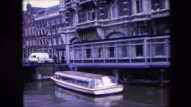 Amsterdam Netherlands (1967): Boat Resting In A Canal Near Buildings