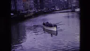 Amsterdam Netherlands (1967): Men Rowing Boat In River In City