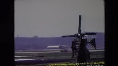 Amsterdam Netherlands (1967): Man Climbing Down A Ladder Against A Windmill Set In