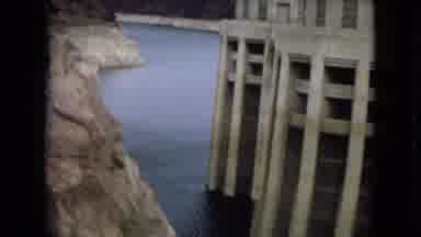 Arizona (1967): Two Structures Connected By A Bridge Over Still Water Next To A