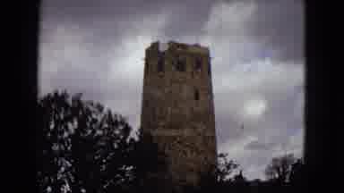 Arizona (1967): A Brick Tower Standing Among A Mountainous Forest.