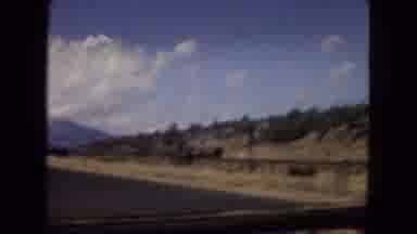 Arizona (1967): Landscape Passes As Car Drives Along Highway Passing Few Other