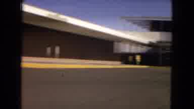 Arizona (1967): A School Building On A Sunny Day That Leads To Hills Of Sand On A