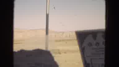 Arizona (1967): In A Vehicle, Moving Past The Desert And Mountains.
