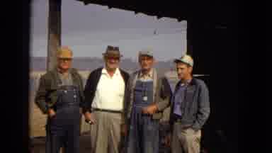 Arizona (1967): Four Older Men Standing Under A Building's Porch Roof