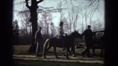 Arizona-1967: Girl Riding Small Horse Led by Man in Rural Setting
