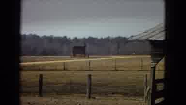 Arizona (1967): An Empty Field With Posts And A Barn To The Right.
