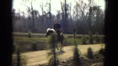 Arizona (1967): A Man Riding A Horse Down A Dirt Road
