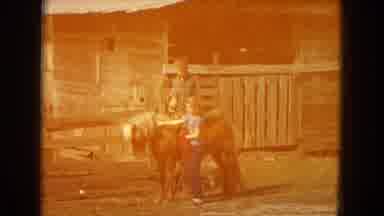 Arizona-1967: Man And Girl Stand By Stable And Pony As The Girl Smooths The