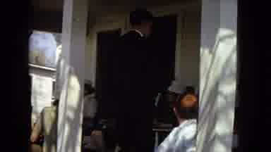 Arizona (1967): Front Porch Gathering With Rocking Chairs, Man Smiles Holding