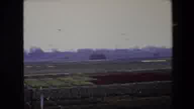 BRUSSELS BELGIUM-1967: Overcast Landscape With Cultivated Fields And Distant Buildings