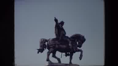 Brussels Belgium (1967): A Car Drives By An Old Building, And A View Of A Statue