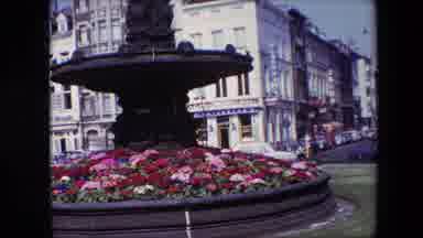Brussels Belgium (1967): Fountain Surrounded By Flowers In A Town Square During A