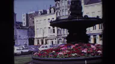 Brussels Belgium (1967): A Water Fountain In Front Of A Row Of Buildings.