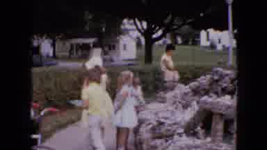 Iowa USA (1967): Several Children And A Lady Watching A Christmas Crib