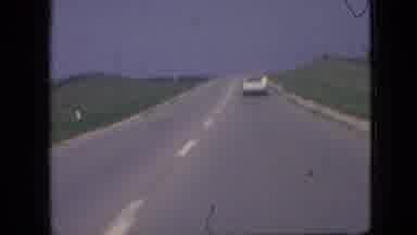 Iowa USA (1967): Speeding Car Racing Through The Countryside Bordering The City