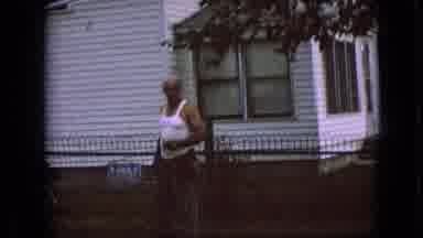 Iowa USA (1967): Man Talking And Holding A Drink As He Walks Towards His Car