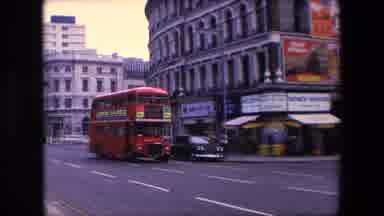 London England (1967): Red Double Decker Bus Turns Around Street Corner