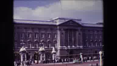 London England (1967): Green And White Bus Drives Past Crowds Walking Near A Large