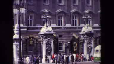 London England (1967): A Crowd Stands Outside A Large Fence And Gate Protecting A