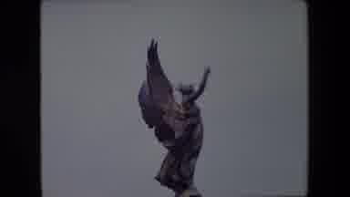London England (1967): An Angel Statue Reaches Toward Blue Sky In The Background