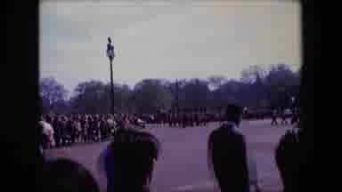 London England (1967): People Crossing The Street While A Parade Procession Passes