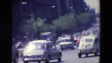 MADRID SPAIN-1967: Classic Cars Driving Down A Busy City Street