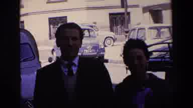 Madrid Spain (1967): A Man And Woman Pose Together In Front Of Cars And A Building