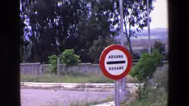 Palermo Italy (1967): Spanish Sign Fence Pavement Red Parking Lot Bushes Distant