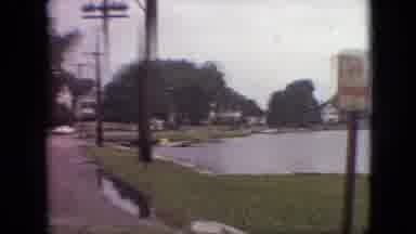 Branson Missouri USA (1968): Driving Past A Lake Facing A Town