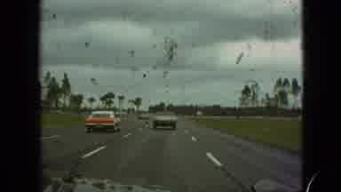 Branson Missouri USA (1968): A Few Cars Traveling Down The Road Lined With Palm