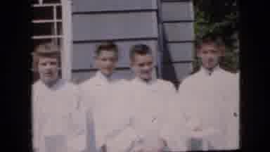 California USA (1969): Line Of Altar Boys Standing Outside Of A Place Of Religion