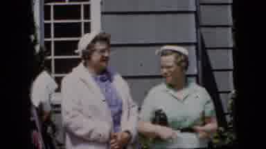 California USA (1969): Ladies Of Wealth Watch The Parade Go By Outside Of Their
