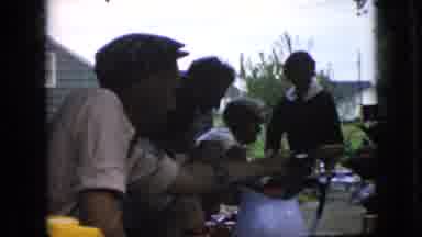 California USA (1969): Hungry People Gather Around The Table To Feast On The Food,