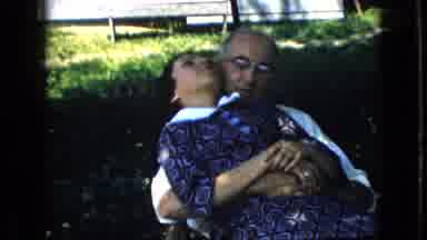 California USA (1969): Man With Arms Around Lady Who Coughs