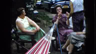 California USA (1969): People Having Fun In Backyard Talking, Playing Lying In