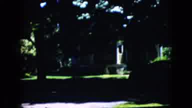California USA (1969): Older Woman In Blue Hat And Dress Walks Down Street