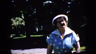 California USA (1969): Old Lady Walking Up To Camera