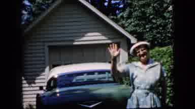 California USA (1969): An Old Lady Standing In Front Of A Car, Waving