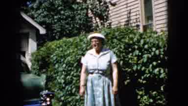 California USA (1969): 1950s Era Woman Waving And Smiling At Camera Next To