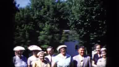 California USA (1969): A Group Of Mature People Pose Together In Front Of A Line